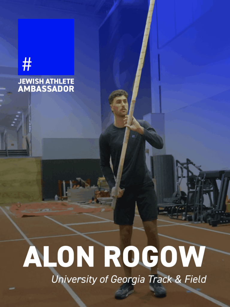 Alon Rogow, University of Georgia track and field athlete, holding a pole vault pole indoors, featured as a Jewish Athlete Ambassador.