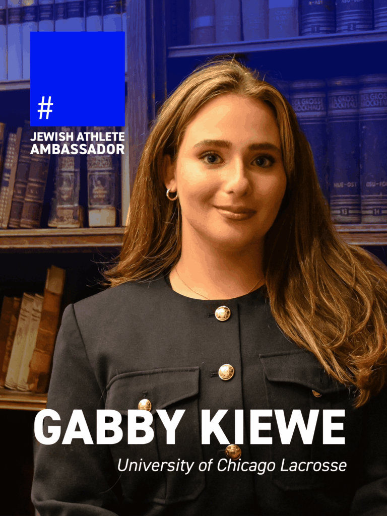 Gabby Kiewe, University of Chicago lacrosse player, standing in front of bookshelves, featured as a Jewish Athlete Ambassador.