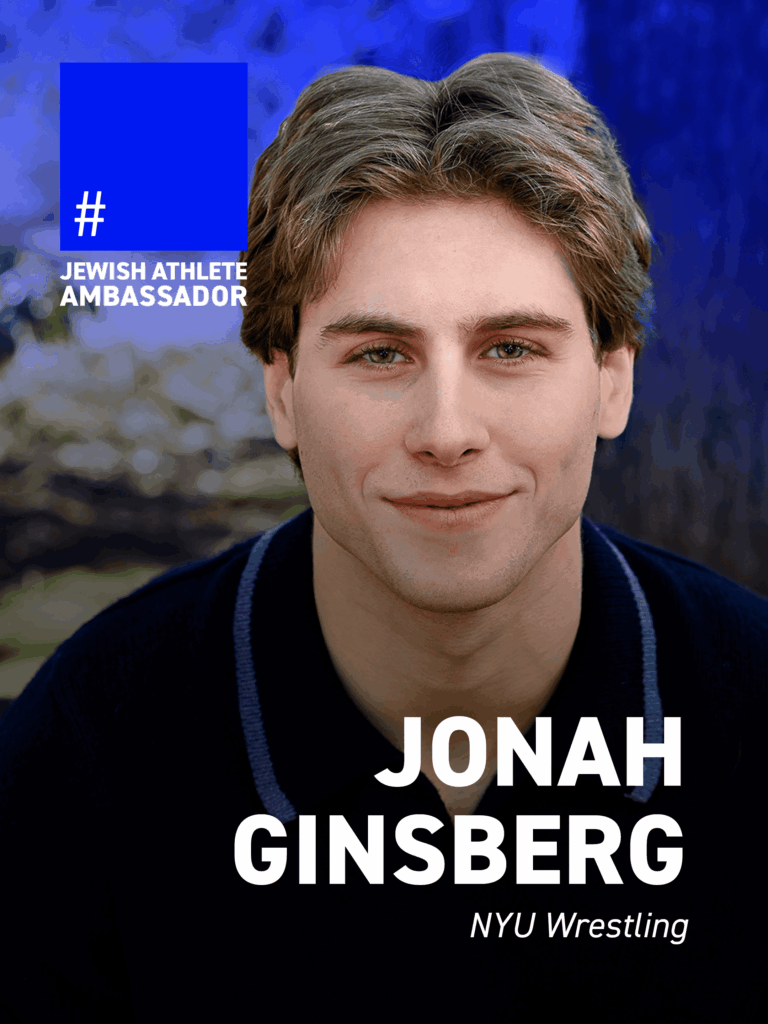 Jonah Ginsberg is pictured outdoors in a close-up portrait, with trees and soft natural light in the background. He wears a dark top and looks directly at the camera with a relaxed, confident expression. A blue overlay in the upper left corner reads “Jewish Athlete Ambassador.” Bold white text at the bottom identifies him as Jonah Ginsberg, followed by “NYU Wrestling.”