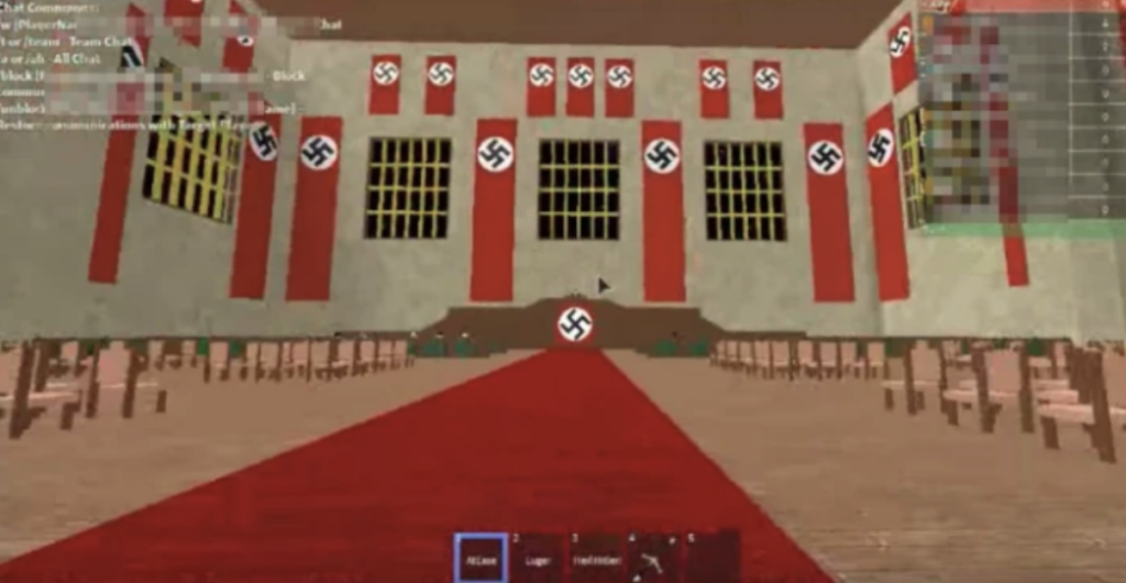 Screenshot from a public Roblox server showing user-created environment with visible antisemitic symbols and offensive text in the game space. 