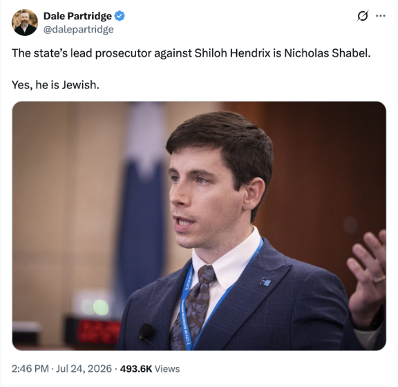 Screenshot of a post on X (formerly Twitter) by the verified account Dale Partridge (@dalepartridge). The post reads:
"The state's lead prosecutor against Shiloh Hendrix is Nicholas Shabel.
Yes, he is Jewish."
Below the text is a photo of a man in a blue suit, white shirt, and patterned tie speaking in what appears to be a courtroom or official setting. He is mid-gesture with one hand raised, wearing a blue lanyard, and looking to his left. The background is softly blurred with wood paneling and part of a flag visible.