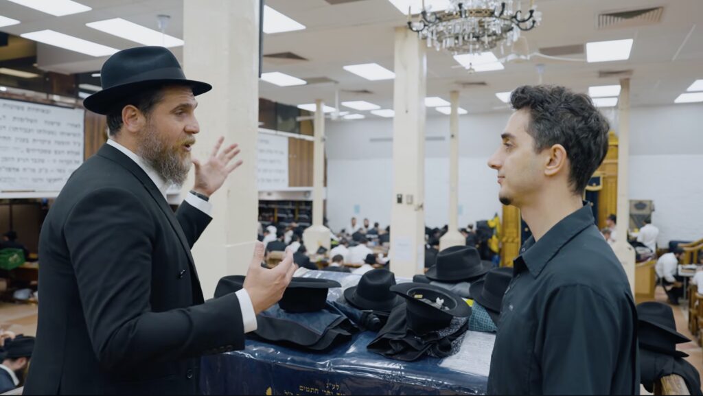 Screenshot from documentary depicting Ruhi Cenet talking with Rabbi Katz of Chabad.