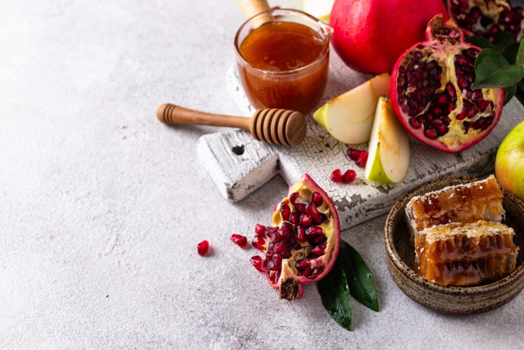 Rosh Hashana concept with honey, apple and pomegranate