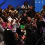 The congregation stands and raises hands during Stand Up Sunday at Bright Star Church in Chicago.