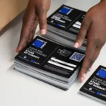 Hands arrange Stand Up Sunday resource cards at Bright Star Church in Chicago.